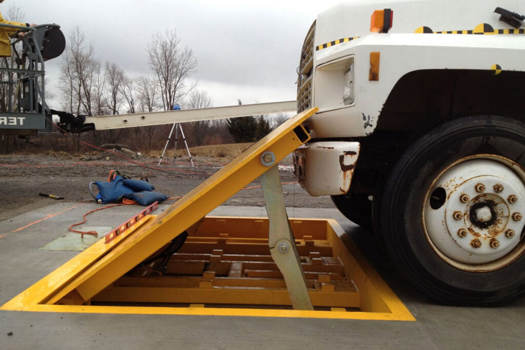 Anti-ram crash-rated barriers raised from ground to stop vehicle approaching a secured facility.